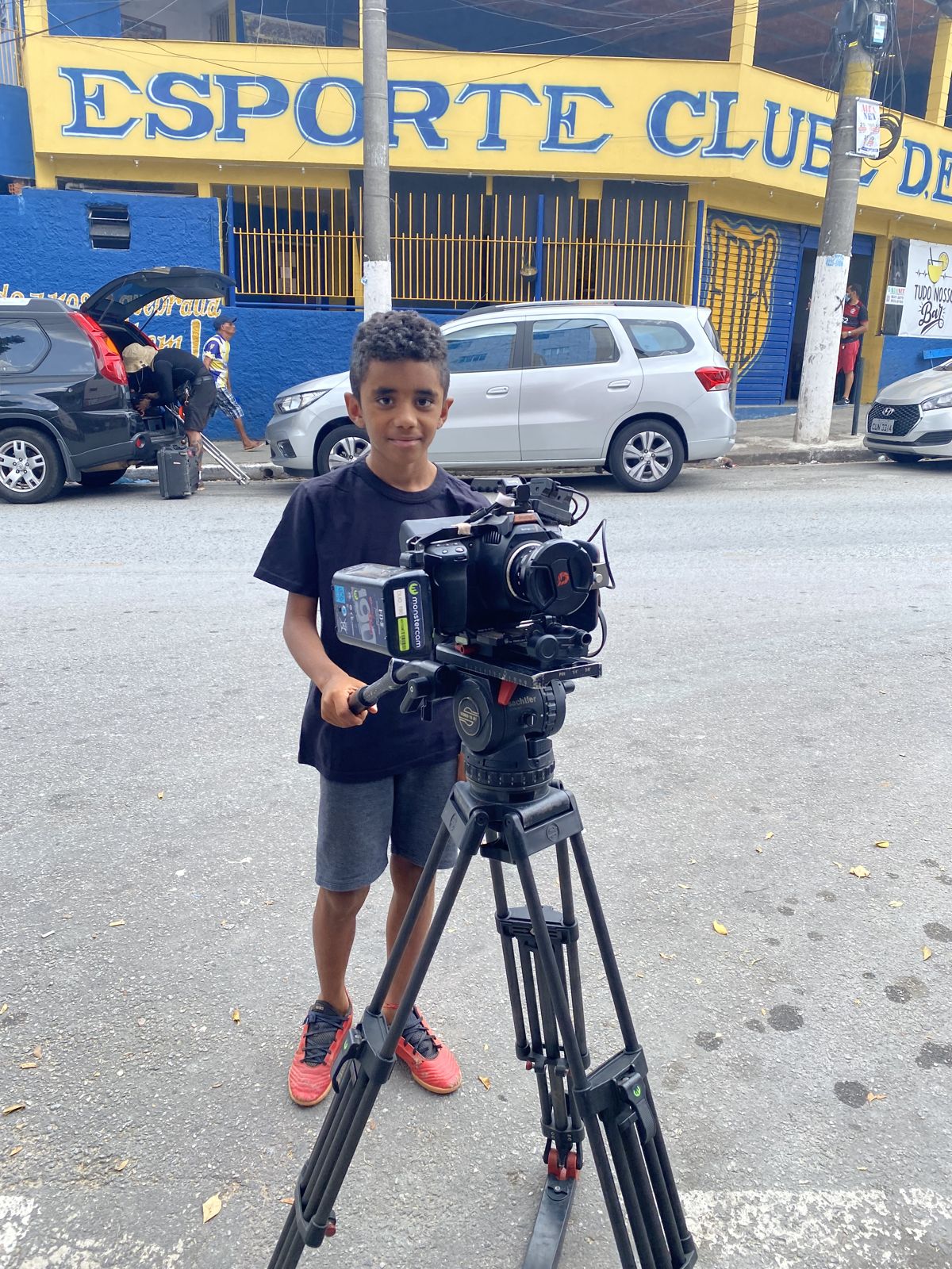 A local boy operates the cinema camera on its tripod