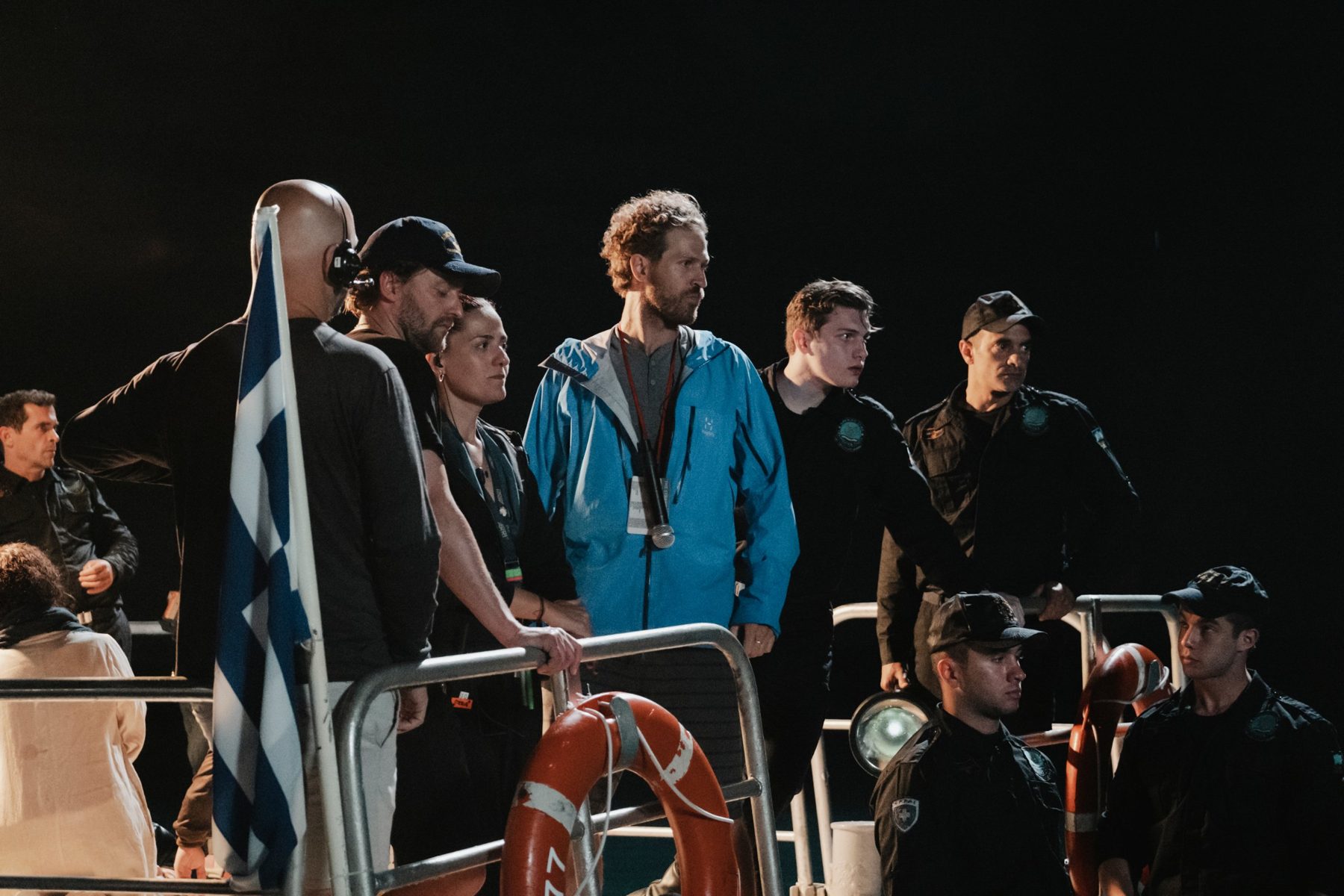 Nick on deck with cast and crew during a night shoot at sea