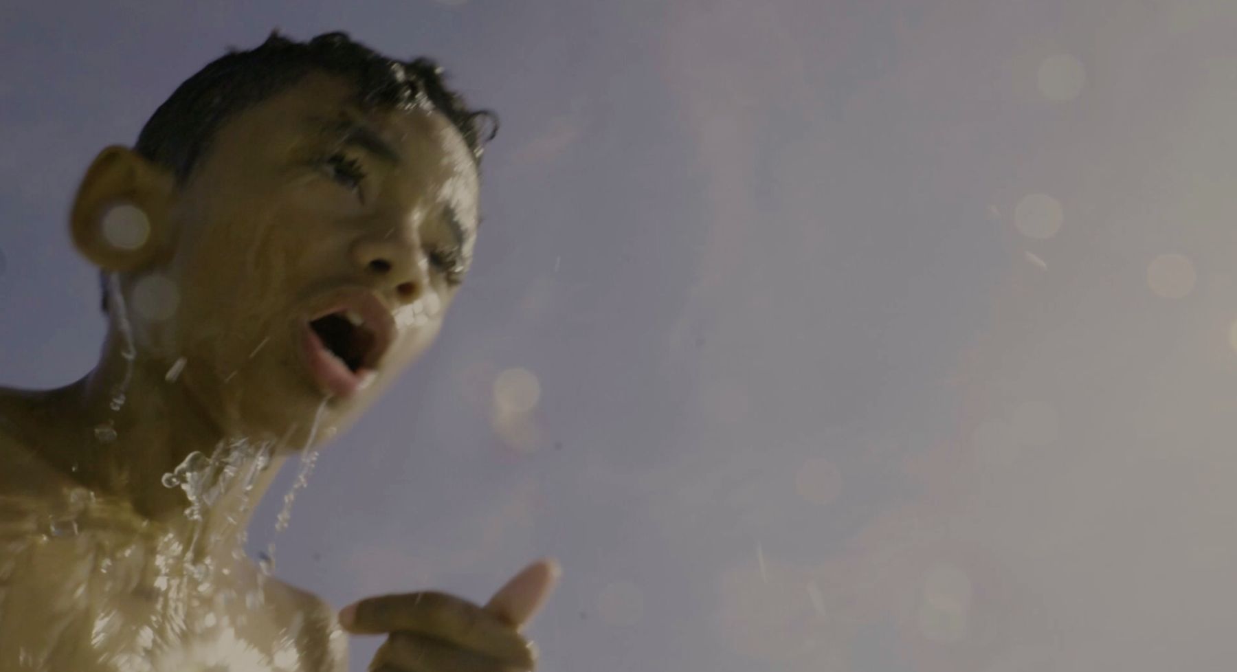 The boy gasps for air, water streaming from his face