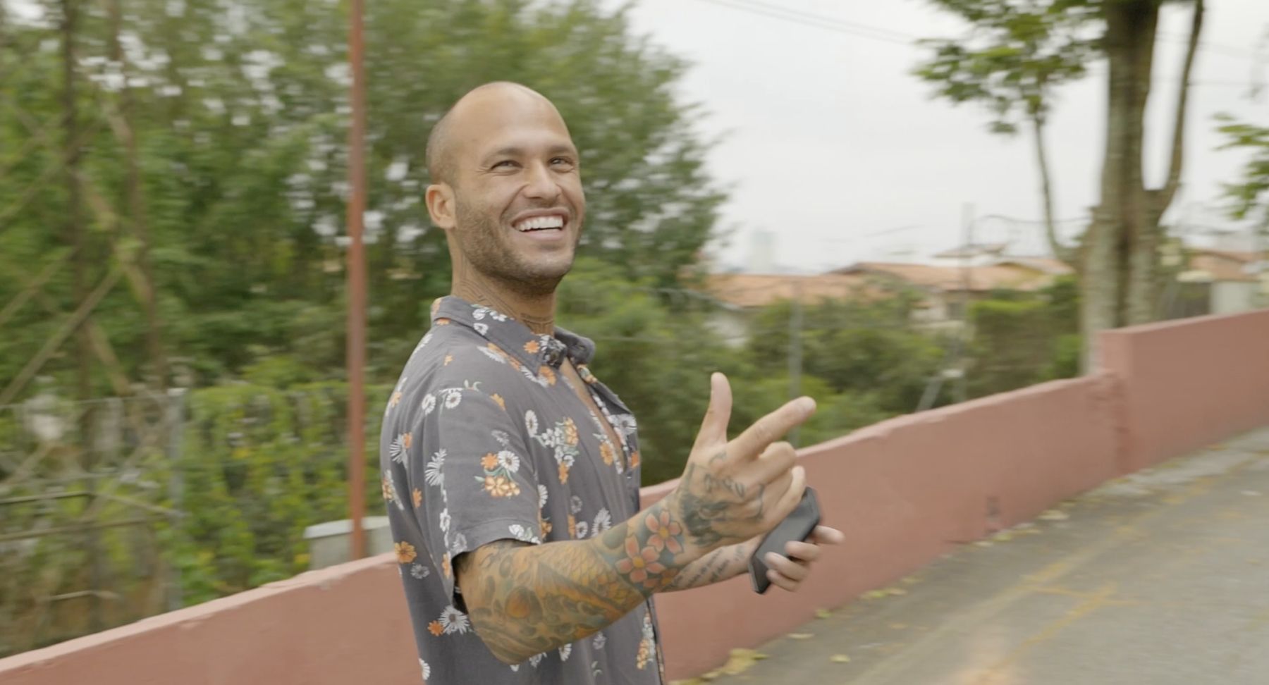 Marcelo laughs and points back down the street