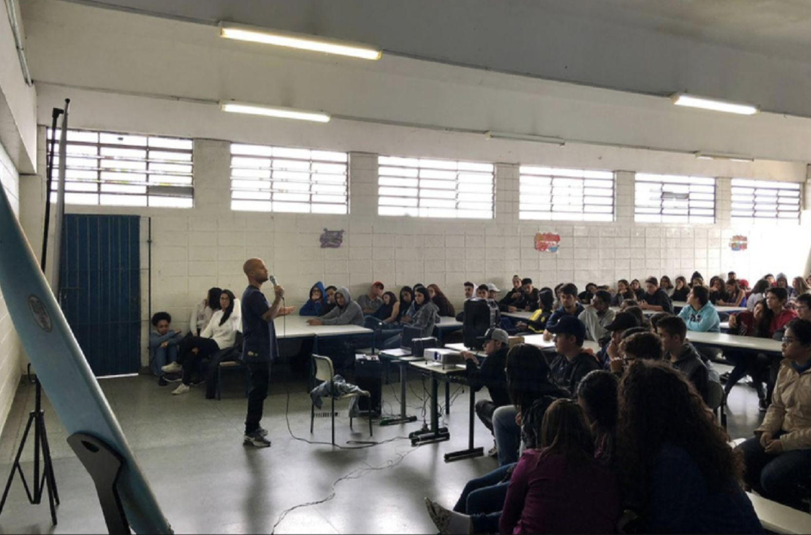 Marcelo speaks to a packed school canteen