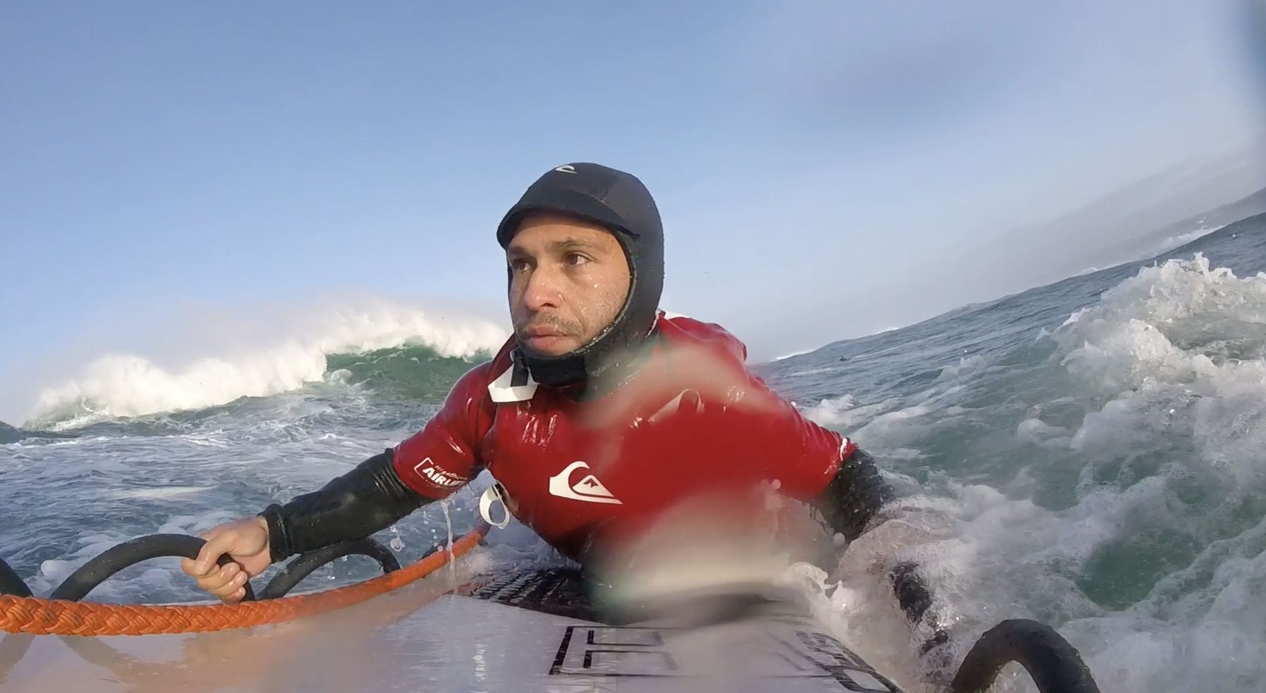 Point-of-view: Marcelo grips the tow sled as a wave breaks behind him